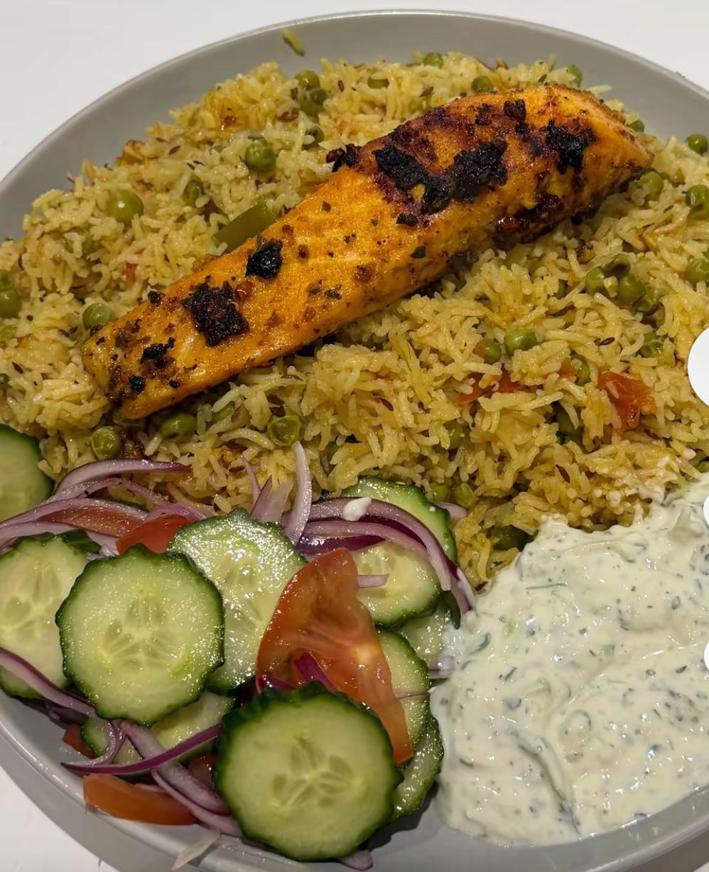 Grilled salmon with seasoned rice at King Kebabish Pizza